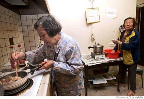 CHINATOWN20_014_LH.JPG This one working stove is shared by 30 units in the complex. Wen Hua Lin, 77 years old, makes herself some lunch. A Chinatown group reports on rampant substandard living conditions in the neighborhood�s rental housing. Photographed by Liz Hafalia on 9/20/05 in San Francisco, California. SFC Creditted to the San Francisco Chronicle/Liz Hafalia